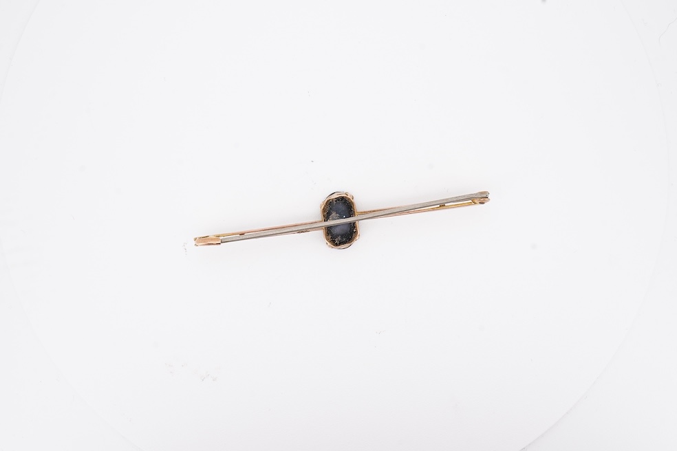 An early 20th century 9ct and single stone oval black opal doublet set bar brooch, 57mm, gross weight 2.3 grams, in an Asprey box. Condition - fair